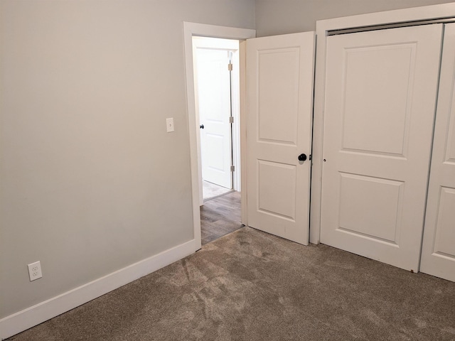 unfurnished bedroom featuring a closet and carpet flooring