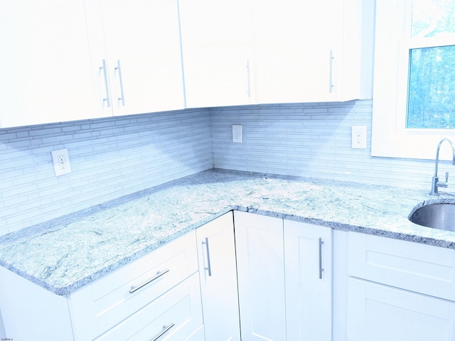 2406 Oslo Ave, Mays Landing, NJ 08330 - kitchen featuring white cabinets, tasteful backsplash, a sink, and light stone counters