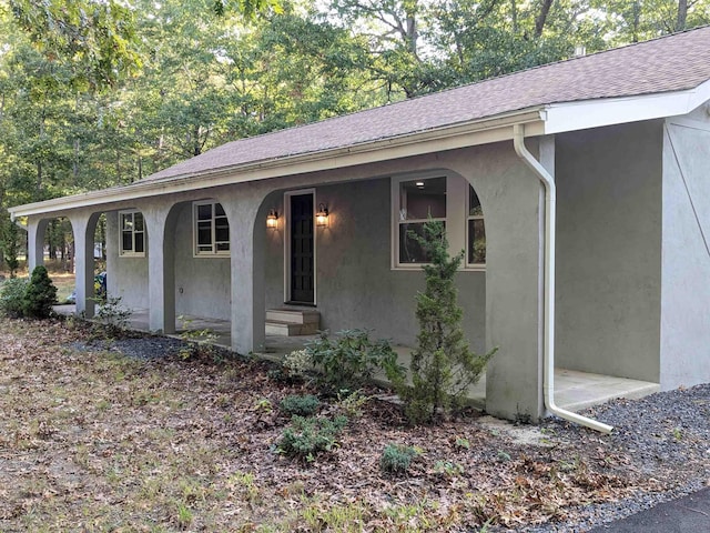 2406 Oslo Ave, Mays Landing, NJ 08330 - view of property exterior with a porch, stucco siding, and roof with shingles