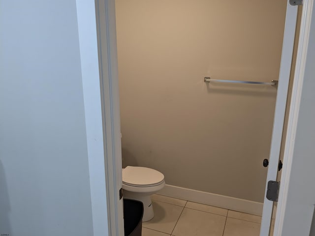 bathroom with toilet and tile patterned floors