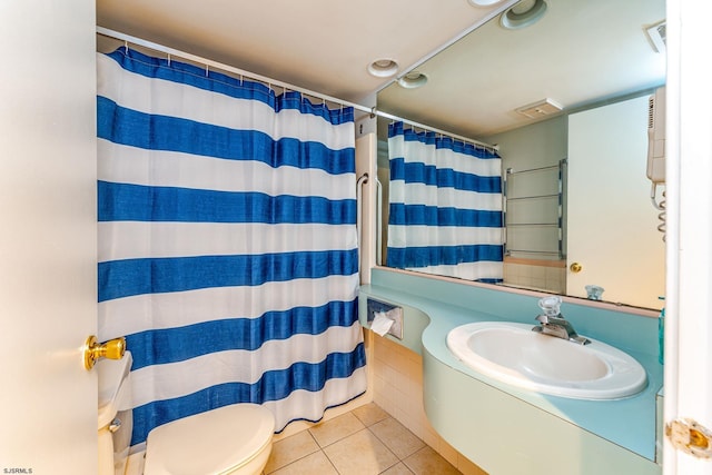 bathroom with curtained shower, tile patterned floors, vanity, and toilet