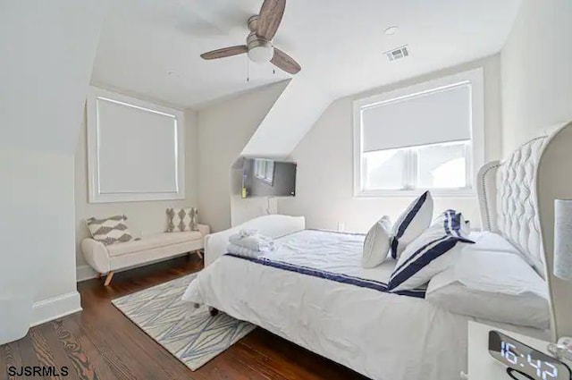 bedroom featuring lofted ceiling, dark hardwood / wood-style flooring, and ceiling fan