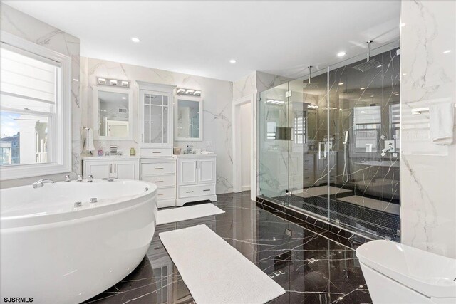 107 S Austin Ave, Ventnor, NJ 08406 - bathroom with marble tiled floors, a marble finish shower, vanity, a freestanding bath, and recessed lighting