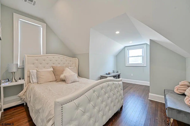 bedroom with dark wood-type flooring and vaulted ceiling