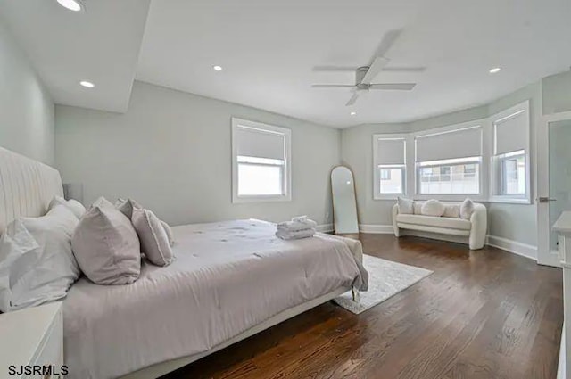 bedroom featuring multiple windows, ceiling fan, and dark hardwood / wood-style floors