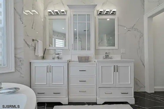 bathroom with a bathing tub, tile patterned flooring, and vanity