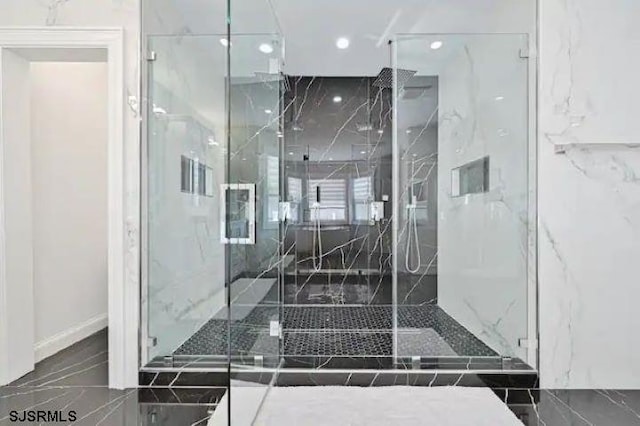 bathroom featuring a shower with door