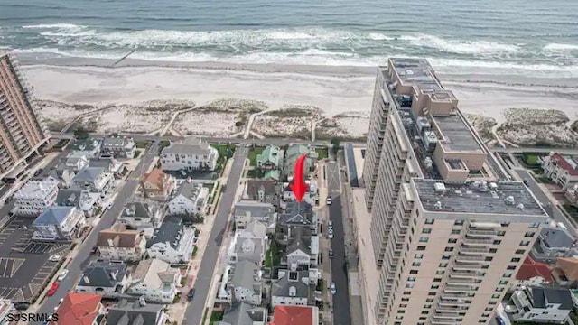 birds eye view of property with a water view and a view of the beach