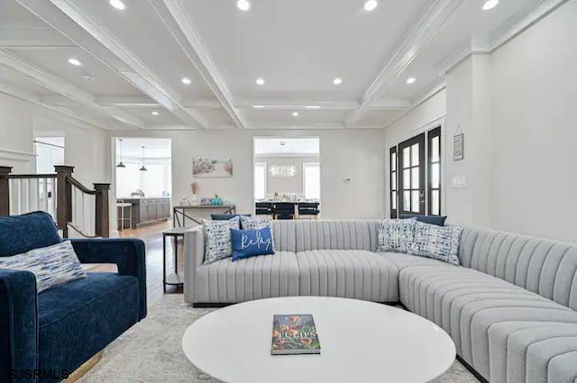 living room with ornamental molding, coffered ceiling, beam ceiling, and light hardwood / wood-style floors