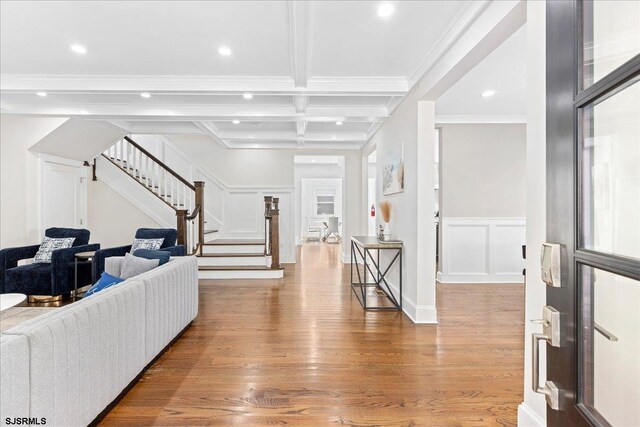 107 S Austin Ave, Ventnor, NJ 08406 - living area featuring stairs, wood finished floors, beamed ceiling, a decorative wall, and coffered ceiling