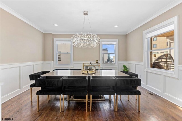 107 S Austin Ave, Ventnor, NJ 08406 - dining room featuring a chandelier, a decorative wall, wood finished floors, a wainscoted wall, and crown molding