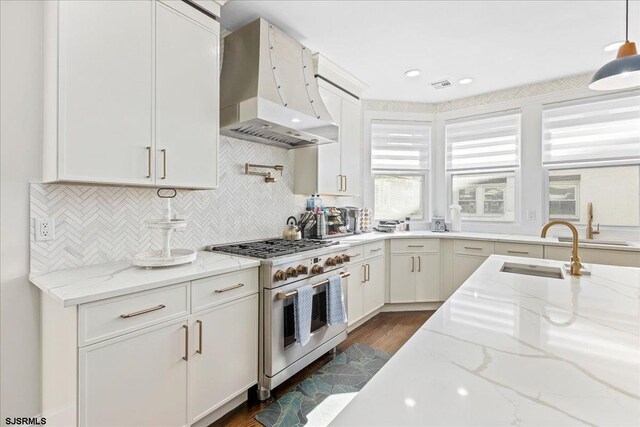 107 S Austin Ave, Ventnor, NJ 08406 - kitchen with range with two ovens, exhaust hood, a sink, white cabinetry, and tasteful backsplash