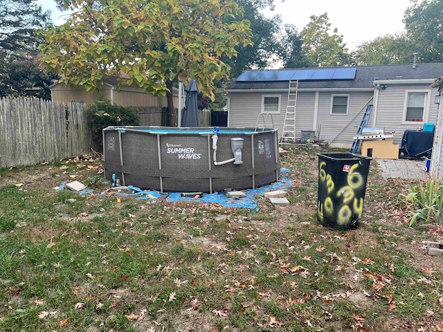 exterior space with central air condition unit and a fenced in pool