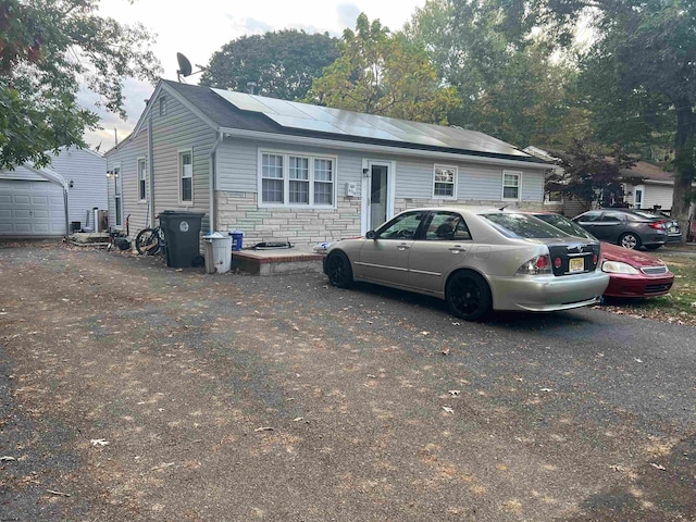 view of front of property featuring solar panels