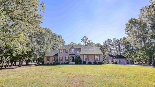 view of front of property featuring a garage and a front lawn