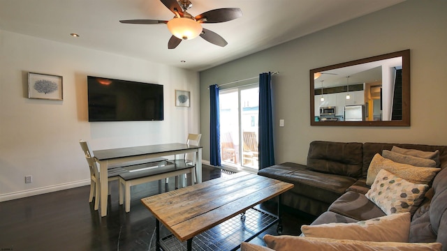 living room with ceiling fan and dark hardwood / wood-style floors