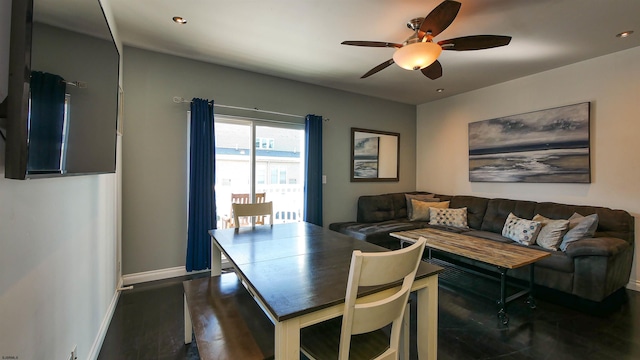 dining area featuring ceiling fan and dark hardwood / wood-style flooring