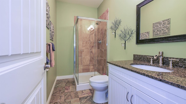 bathroom with vanity, walk in shower, and toilet