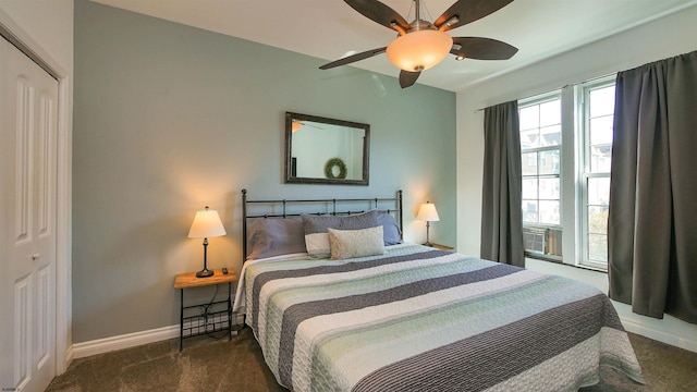 carpeted bedroom with ceiling fan and a closet