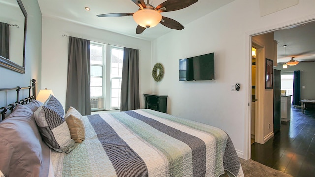 bedroom featuring multiple windows, ceiling fan, and dark hardwood / wood-style floors