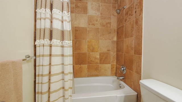 bathroom featuring toilet and shower / bath combo