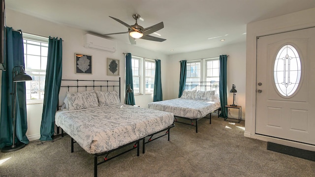 bedroom featuring a wall mounted AC, carpet, and ceiling fan