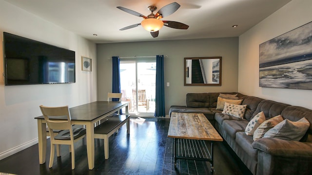 living room with ceiling fan and dark hardwood / wood-style flooring