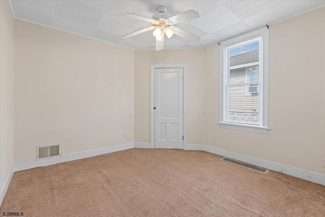 spare room with light colored carpet and ceiling fan