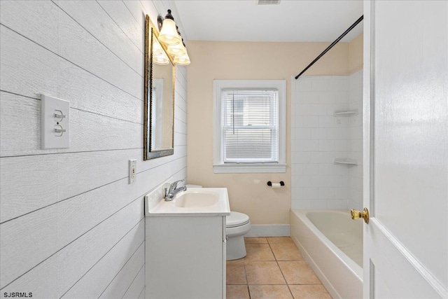 full bathroom featuring tile patterned floors, vanity, toilet, and tiled shower / bath