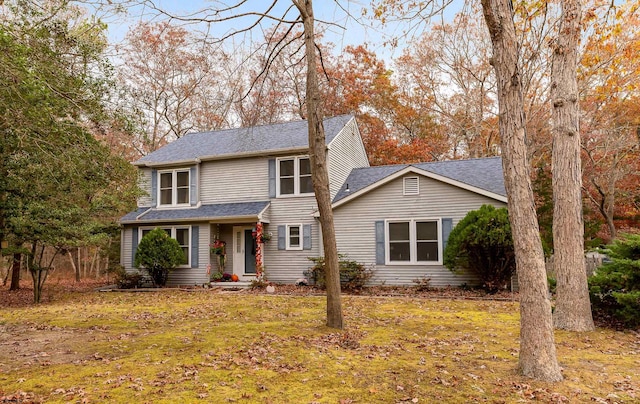 view of property featuring a front lawn