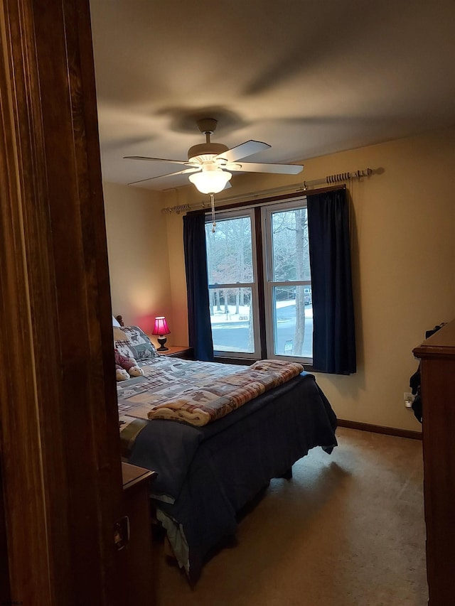 bedroom with ceiling fan and carpet flooring