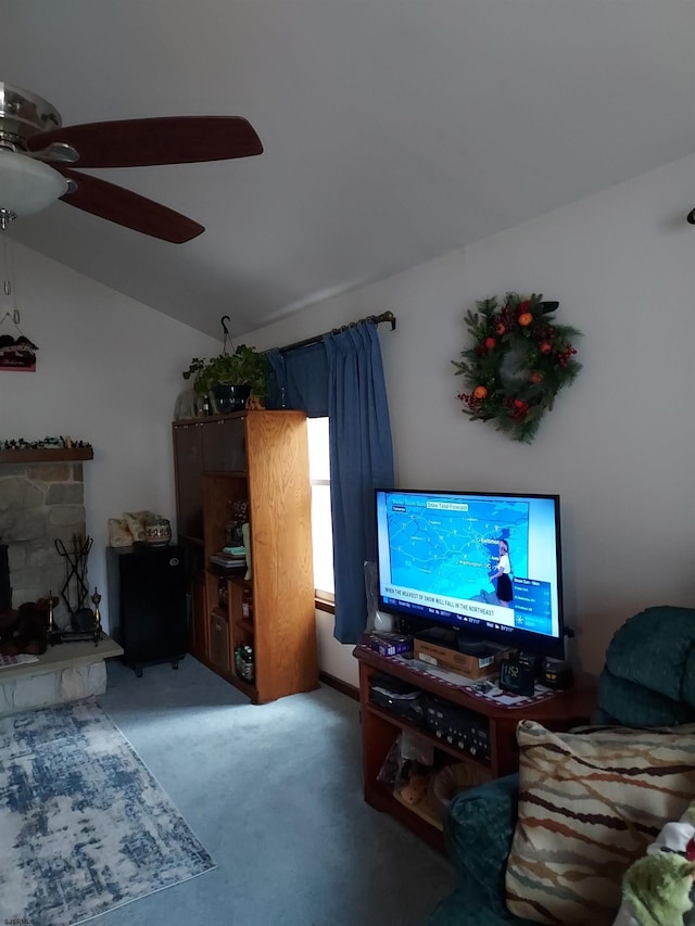 living room featuring ceiling fan, lofted ceiling, a fireplace, and carpet