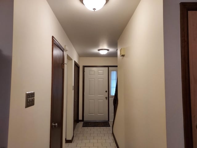 hall with light tile patterned floors