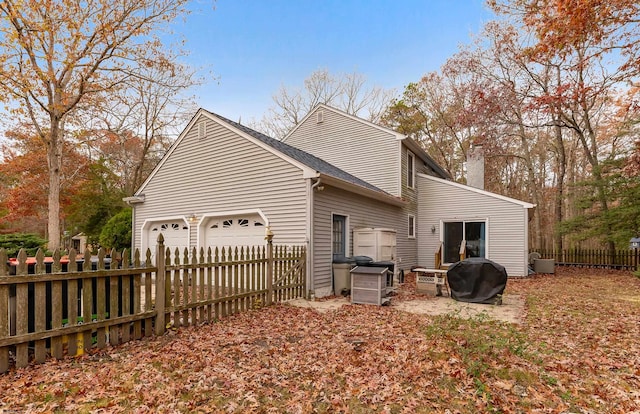 back of house with a garage