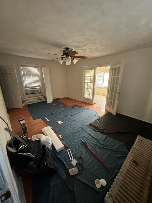 unfurnished living room with ceiling fan and hardwood / wood-style floors