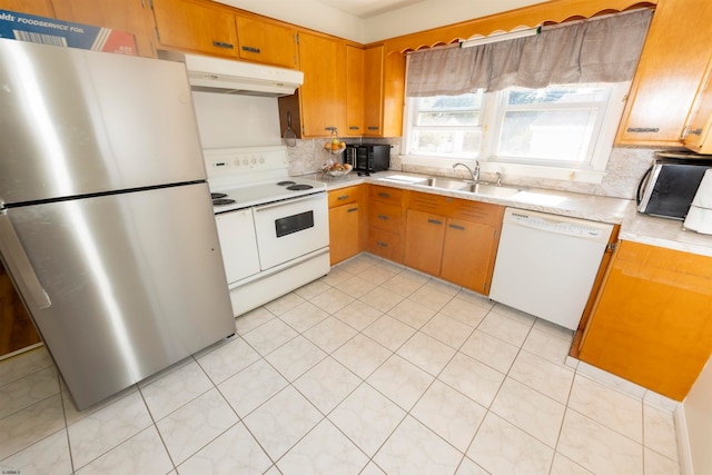 kitchen featuring light tile patterned floors, backsplash, sink, and white appliances