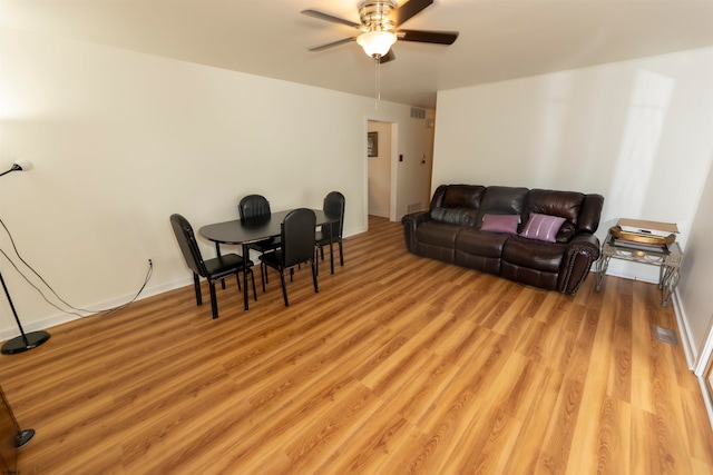 living room featuring light wood-type flooring and ceiling fan