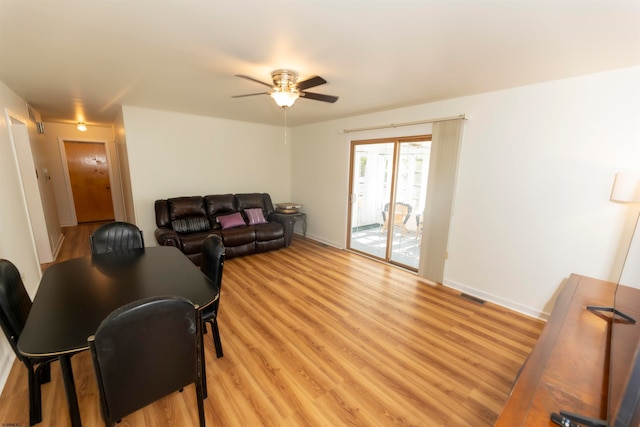 living room featuring light hardwood / wood-style floors and ceiling fan