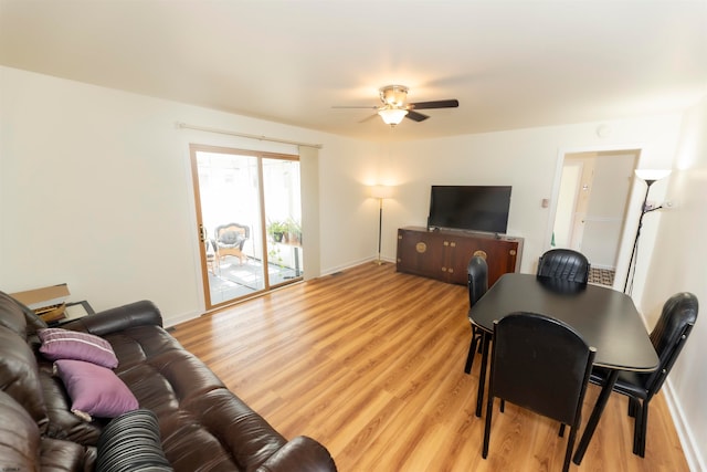 living room with light wood-type flooring and ceiling fan