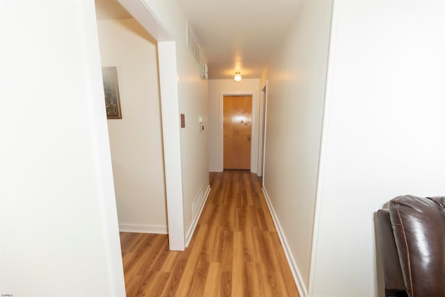 corridor with light hardwood / wood-style flooring