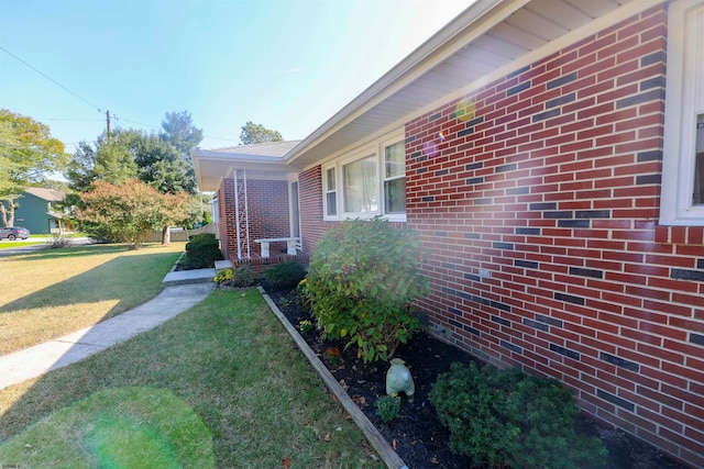 view of home's exterior with a lawn