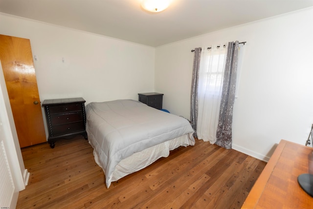 bedroom featuring crown molding and hardwood / wood-style floors