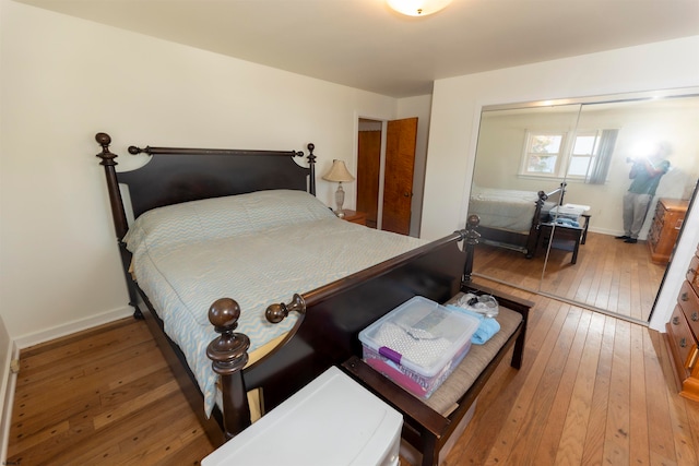 bedroom with wood-type flooring and a closet