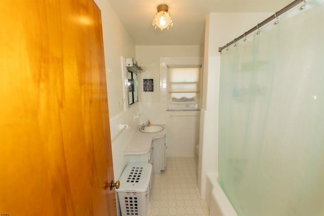 full bathroom featuring tile walls, shower / bath combo, vanity, and toilet