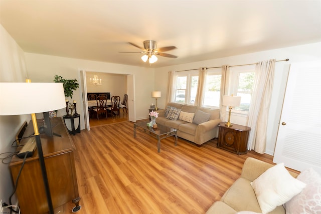 living room with ceiling fan and light hardwood / wood-style flooring