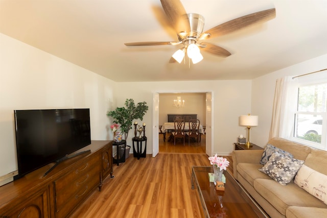 living room with light hardwood / wood-style flooring and ceiling fan