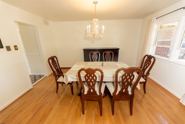 dining area with a chandelier and light wood-type flooring