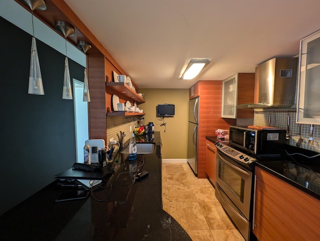 kitchen with wall chimney range hood, stainless steel appliances, light tile patterned floors, a fireplace, and tasteful backsplash