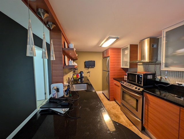 kitchen featuring wall chimney range hood, sink, stainless steel appliances, decorative backsplash, and light tile patterned floors