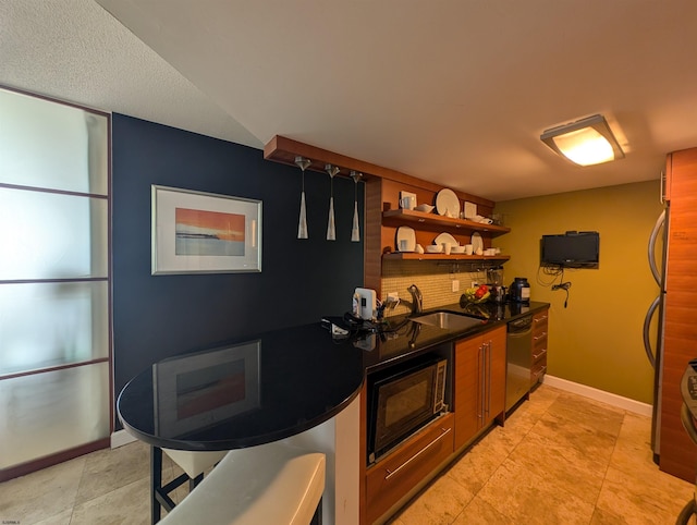 kitchen featuring black microwave, stainless steel dishwasher, and sink